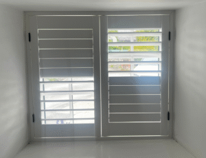 White-finish shutters with classic black hinges in Llanon